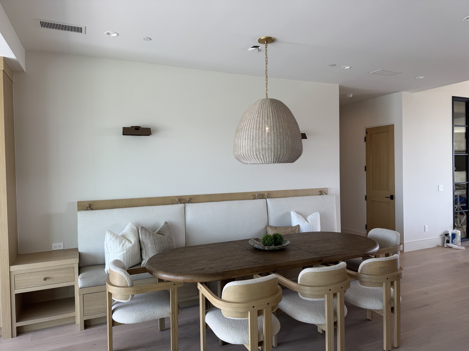 Breakfast room with woven pendant, wall sconces and recessed lighting