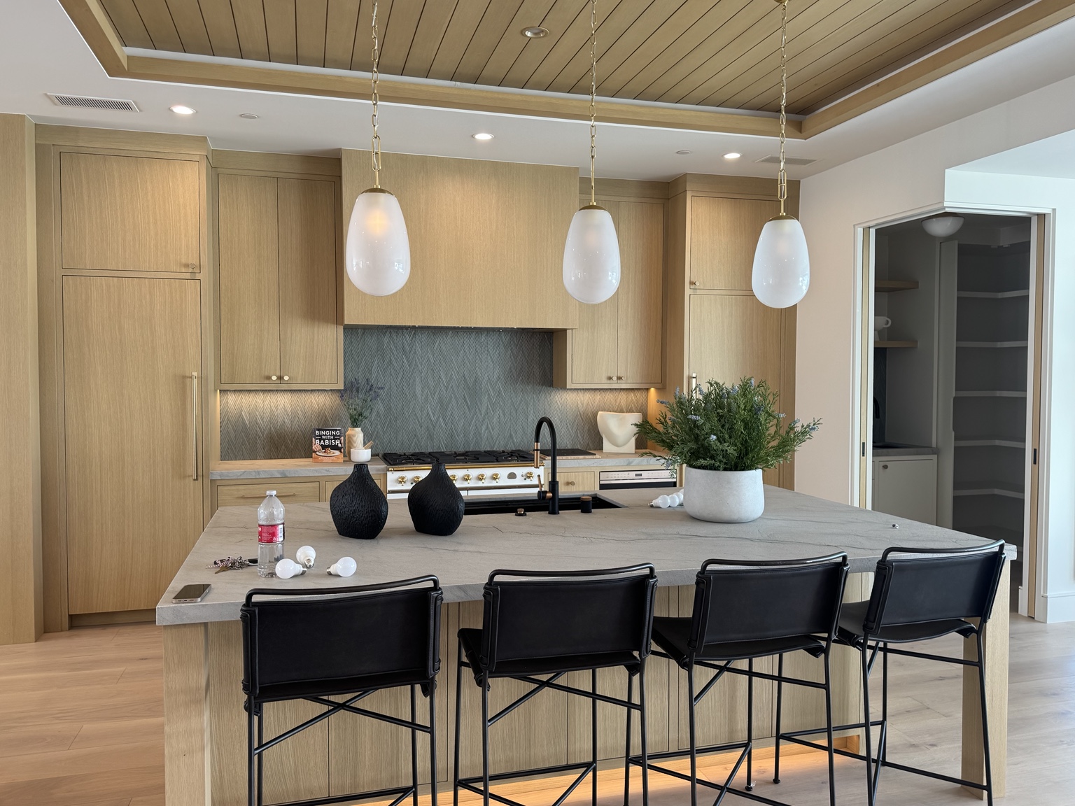 Custom kitchen with pendants, recessed fixtures, under-cabinet and toe-kick lighting