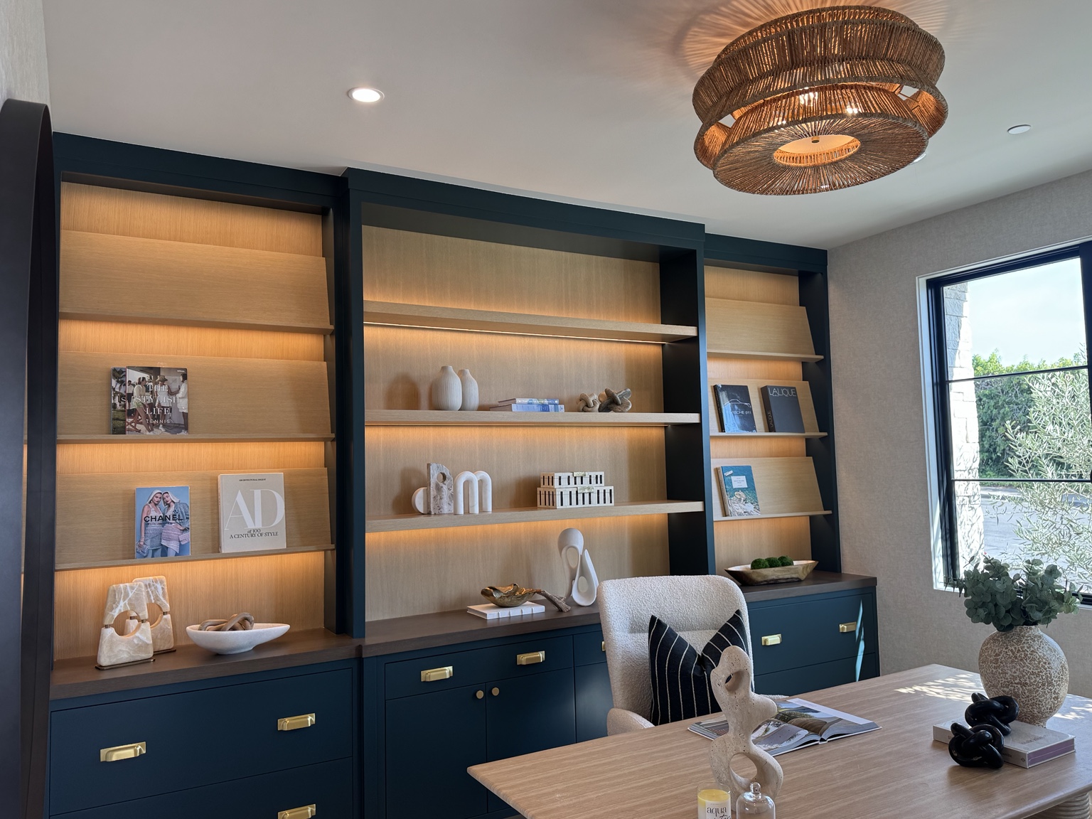 Custom office cabinetry with warm concealed shelf lighting